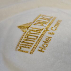 Mineral Palace Hotel & Casino Printed in Gold on a White Fabric.